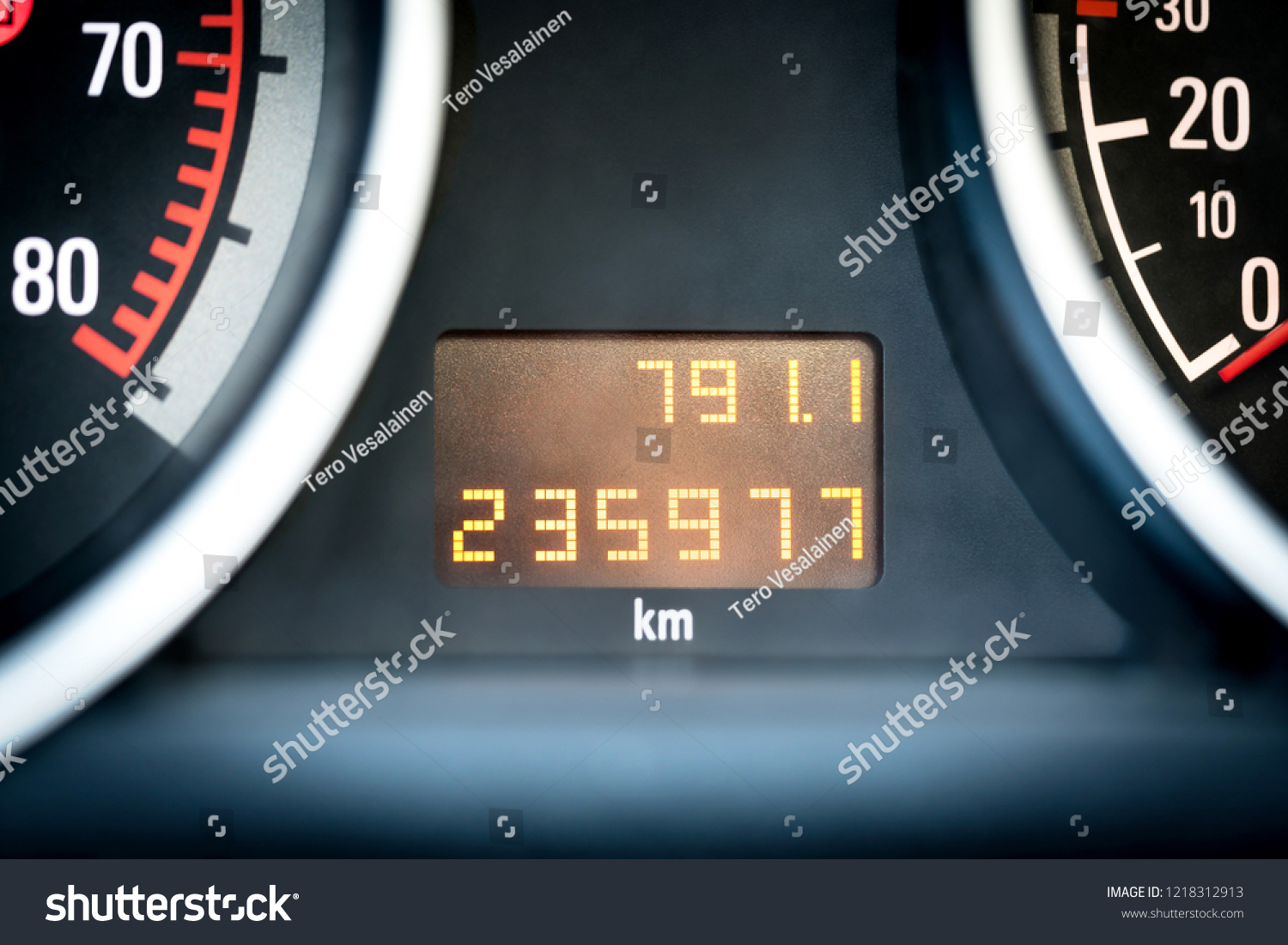 Digital car odometer in dashboard. Used vehicle with mileage meter. Numbers in kilometers. #1218312913