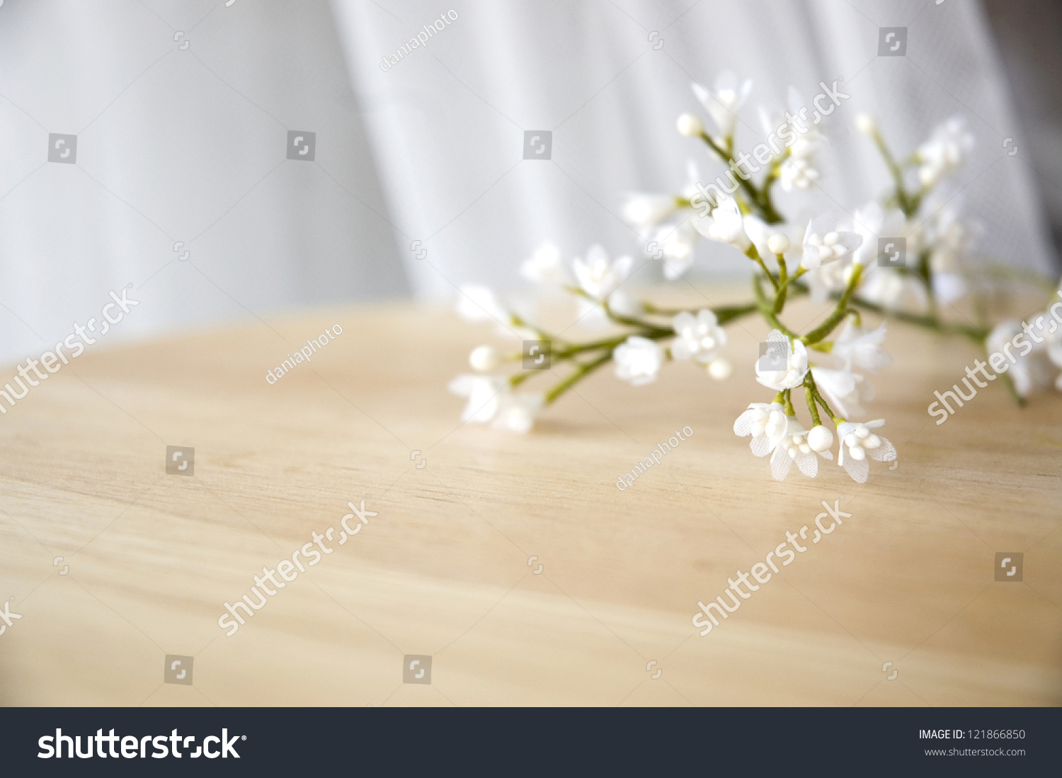 close up white artificial flowers put on table #121866850