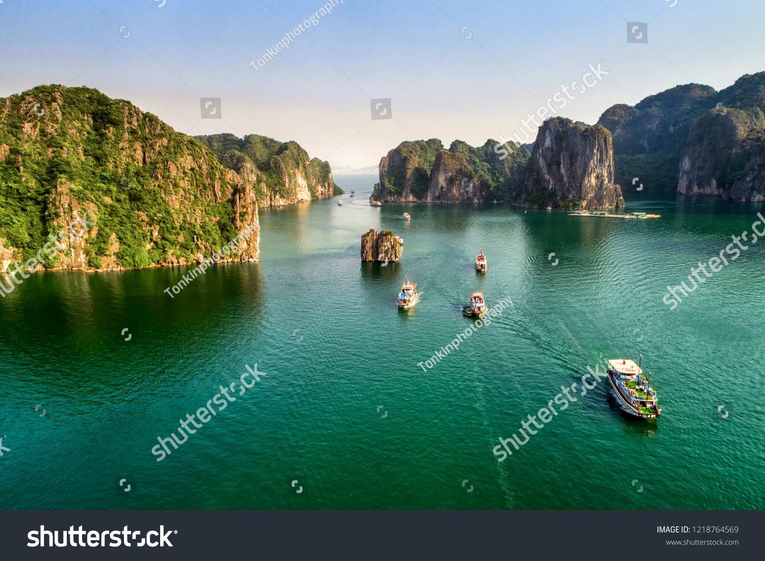 Aerial view floating fishing village and rock island, Halong Bay, Vietnam, Southeast Asia. UNESCO World Heritage Site. Junk boat cruise to Ha Long Bay. Popular landmark, famous destination of Vietnam #1218764569