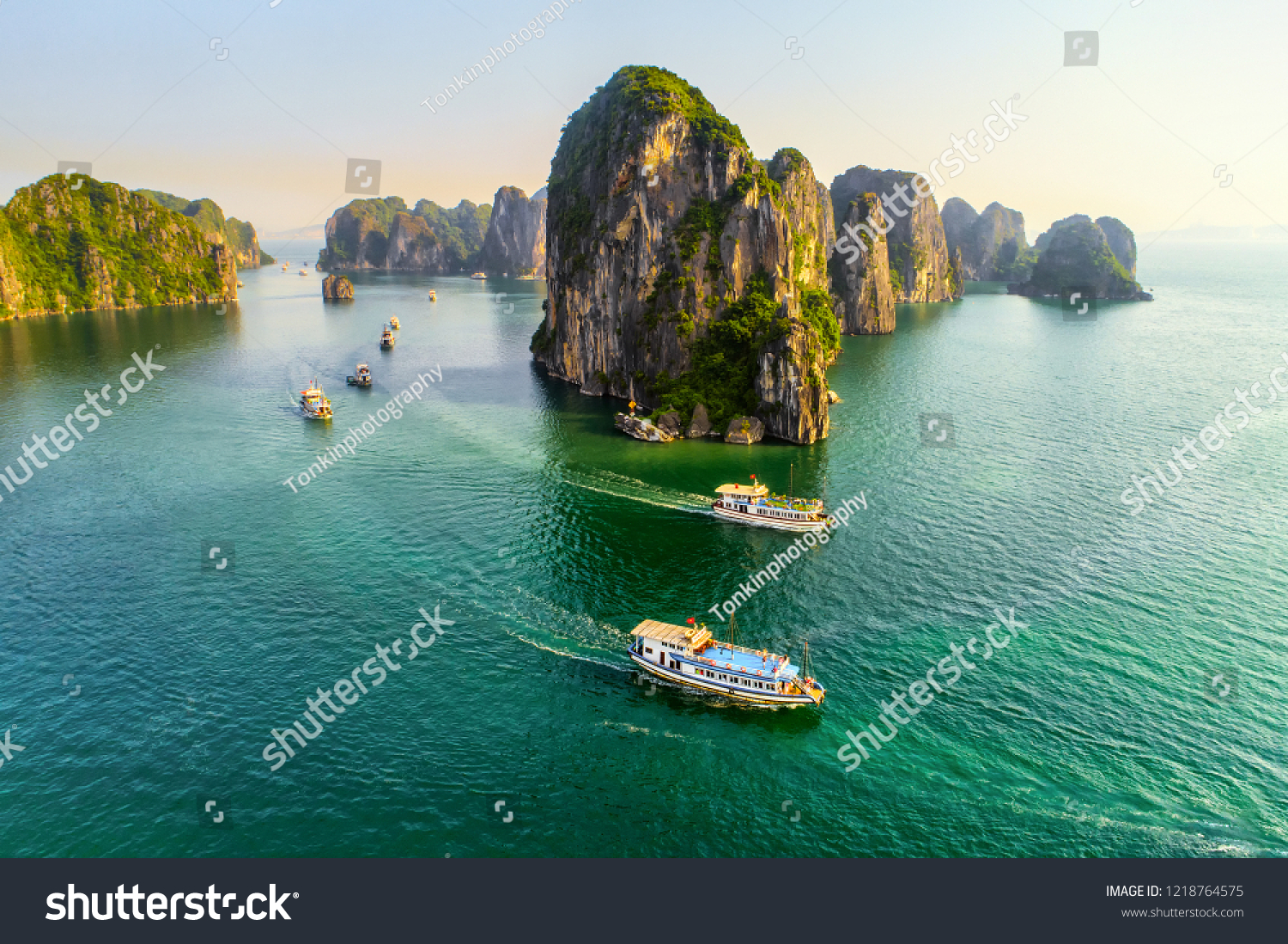 Aerial view floating fishing village and rock island, Halong Bay, Vietnam, Southeast Asia. UNESCO World Heritage Site. Junk boat cruise to Ha Long Bay. Popular landmark, famous destination of Vietnam #1218764575