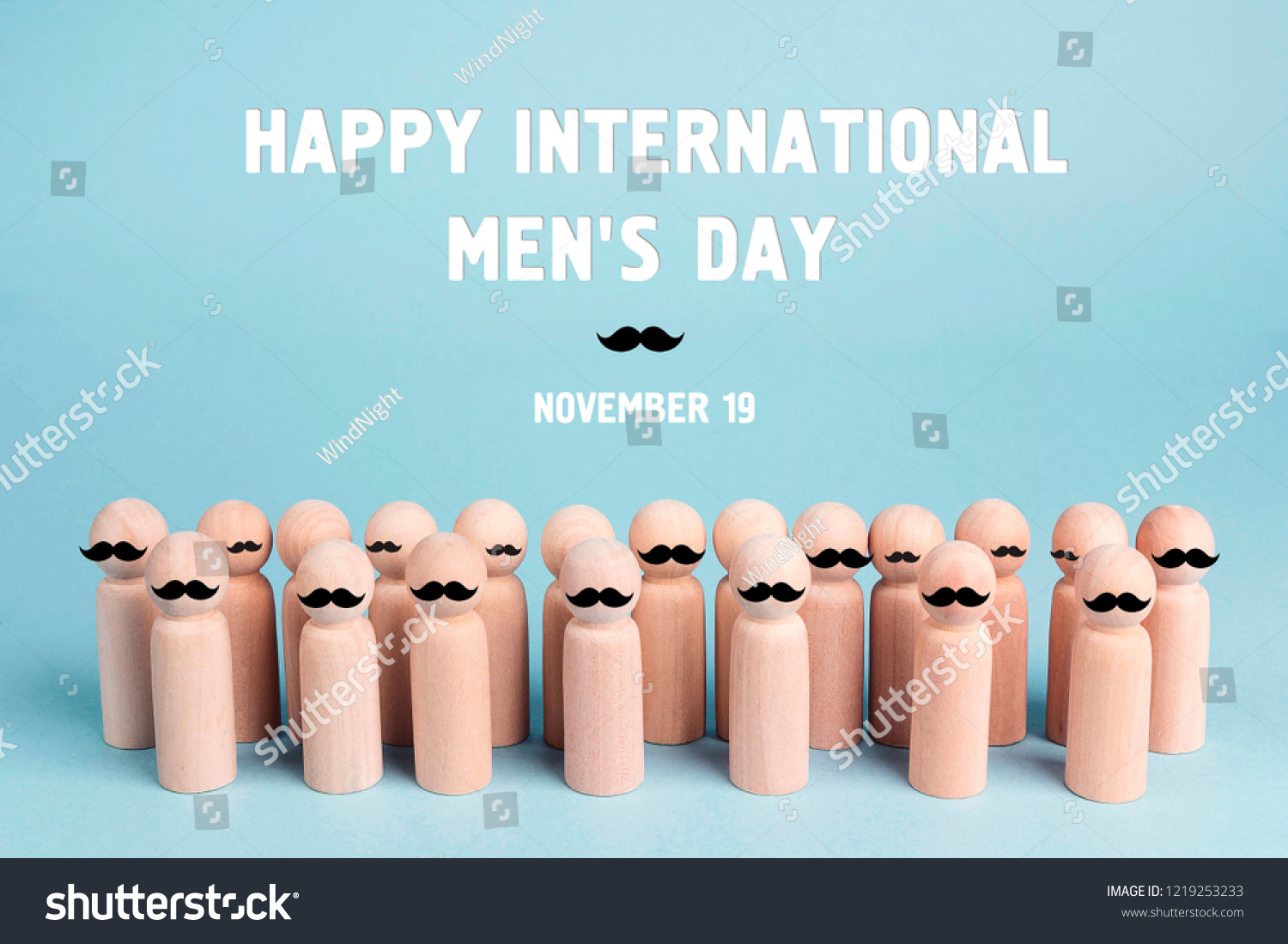 International men's day background with wooden dolls with a mustache on a blue background. #1219253233