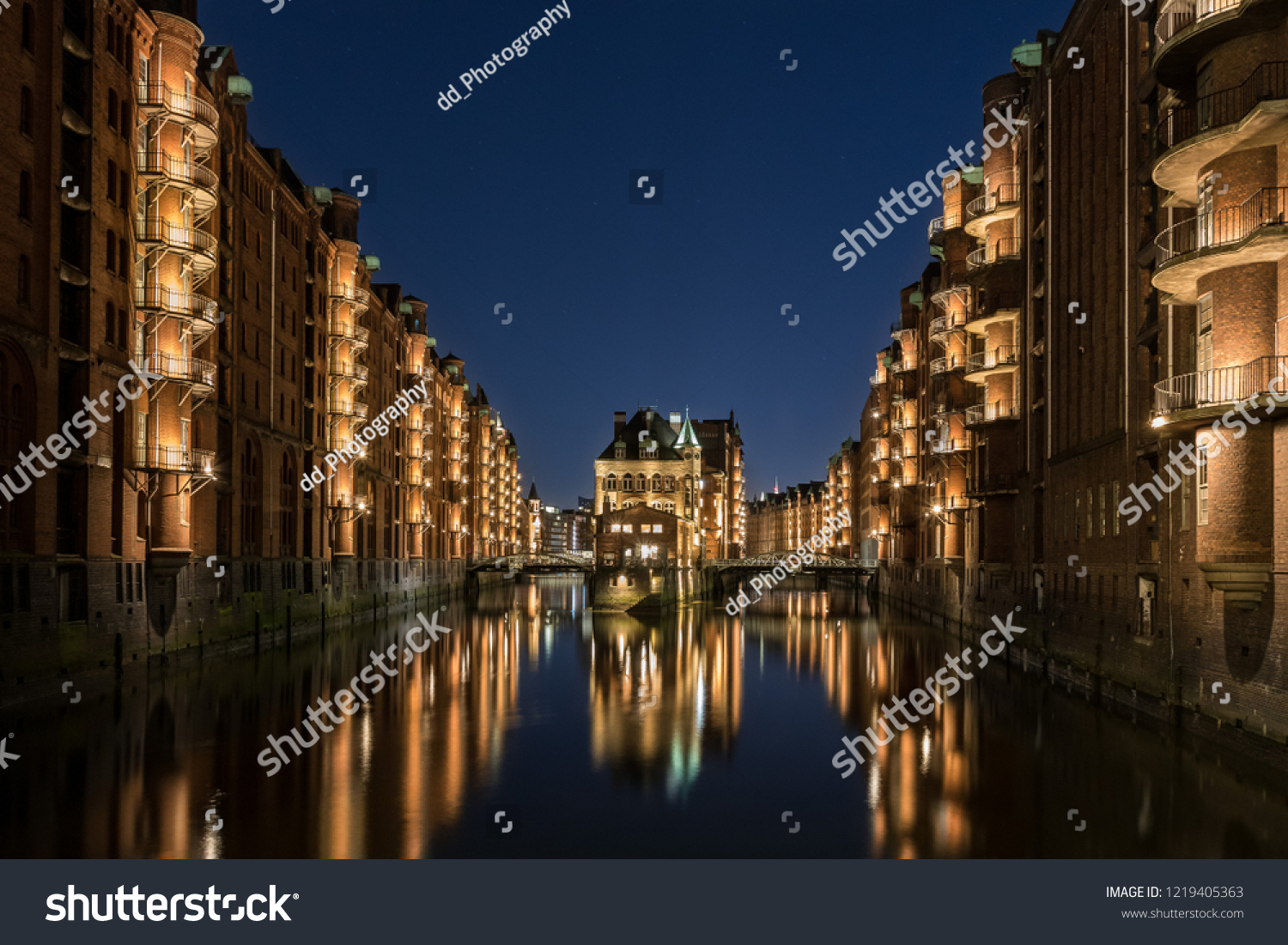 Hamburg Speicherstadt at blue hour. The blue sky and the color of the lights is a nice interaction.  #1219405363