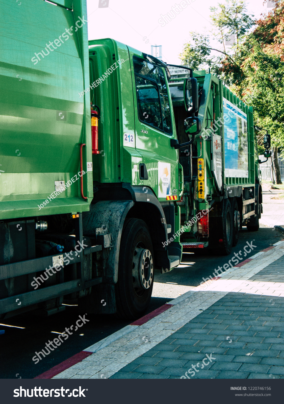 Tel Aviv Israel October 25, 2018  View of a green garbage truck parked in the streets of Tel Aviv in the afternoon #1220746156