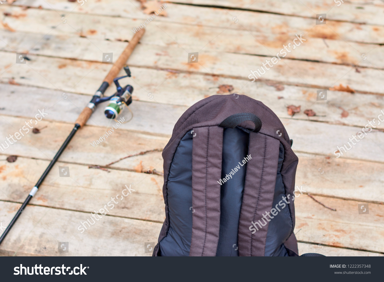 spinning rod and bag on a wooden pier #1222357348