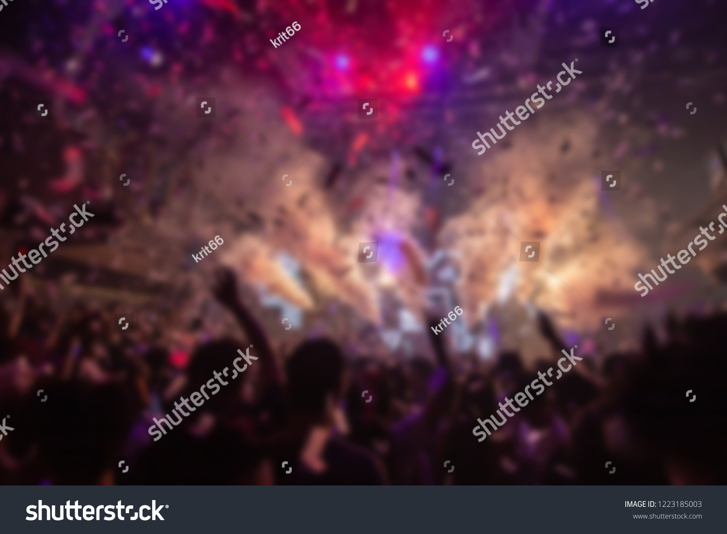 Effects blur Concert, disco dj party. People with hands up having fun  #1223185003