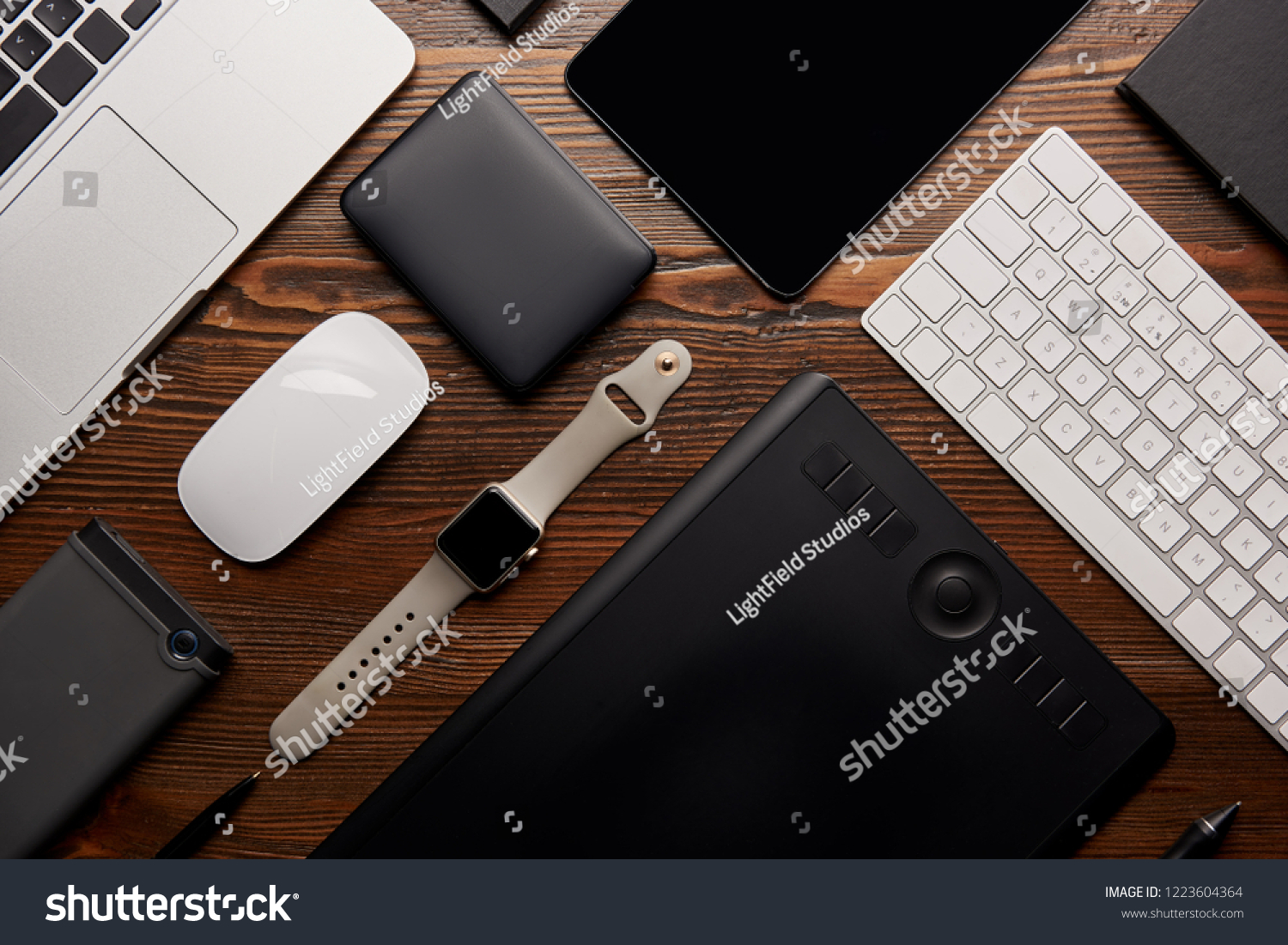 flat lay with different devices on wooden workplace #1223604364