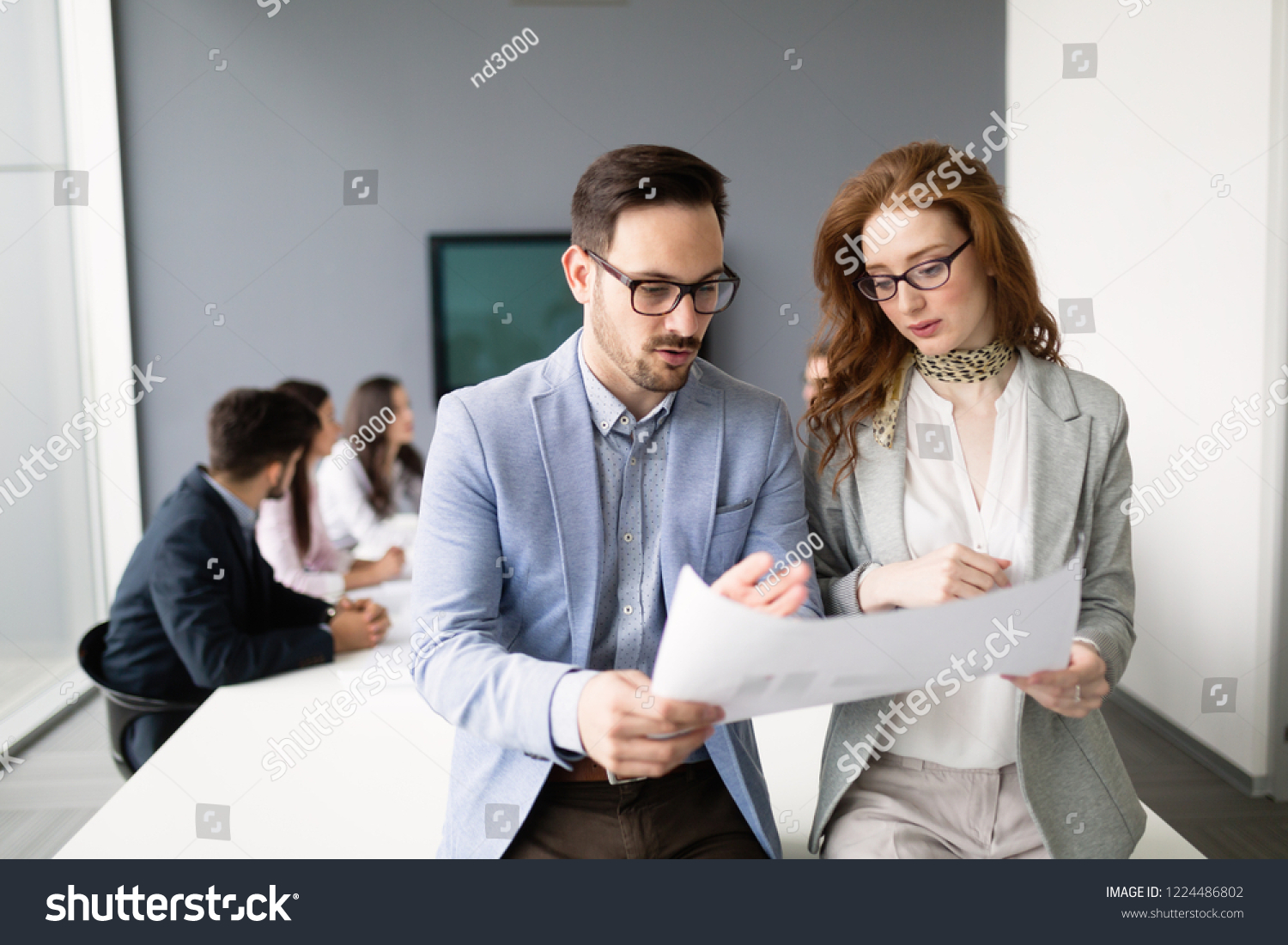 Business colleagues in conference room working together #1224486802