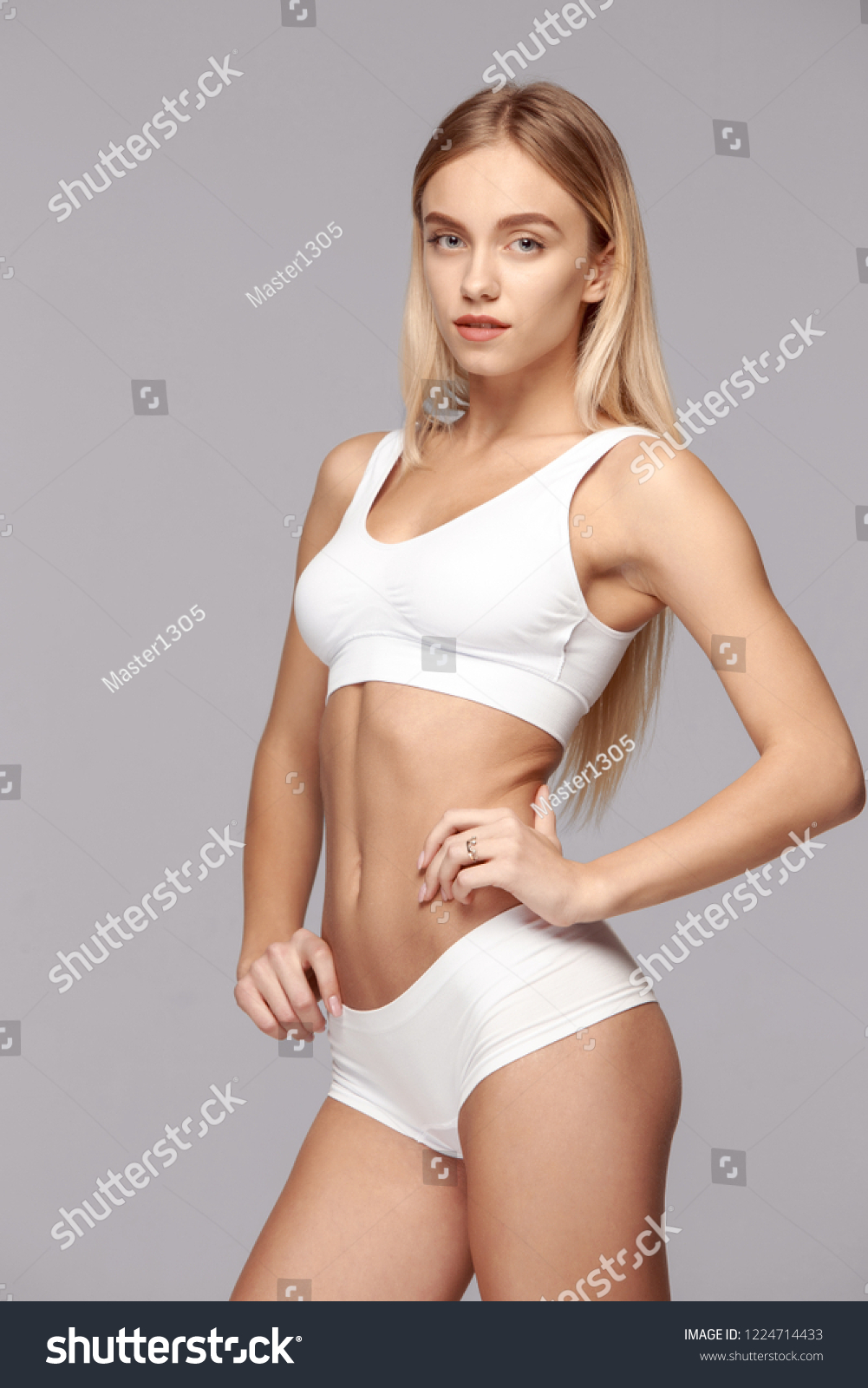 Perfect slim toned young body of the girl or fit woman at studio. The fitness, diet, sports, plastic surgery and aesthetic cosmetology concept. #1224714433