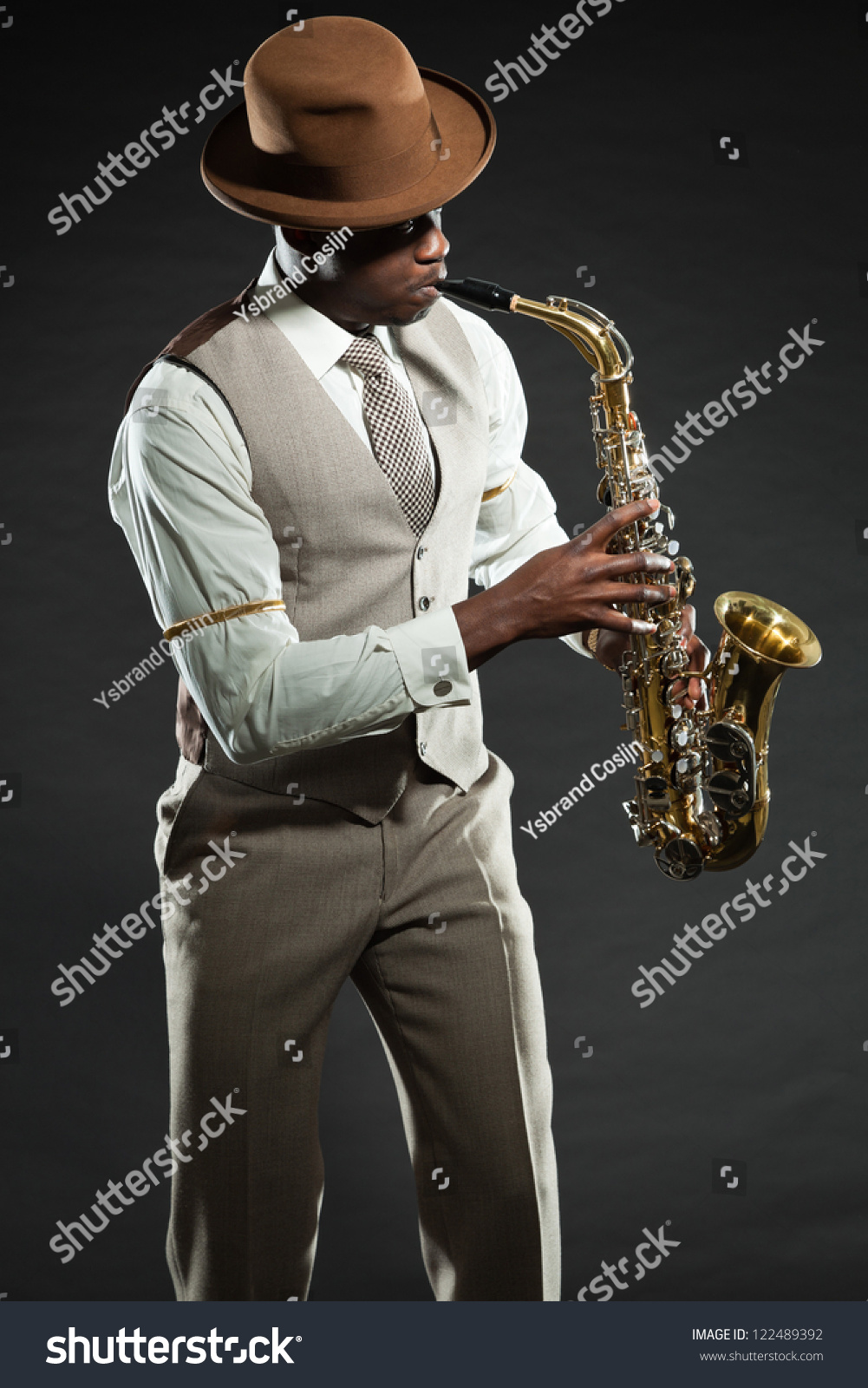 Black american jazz saxophone player. Vintage. Studio shot. #122489392