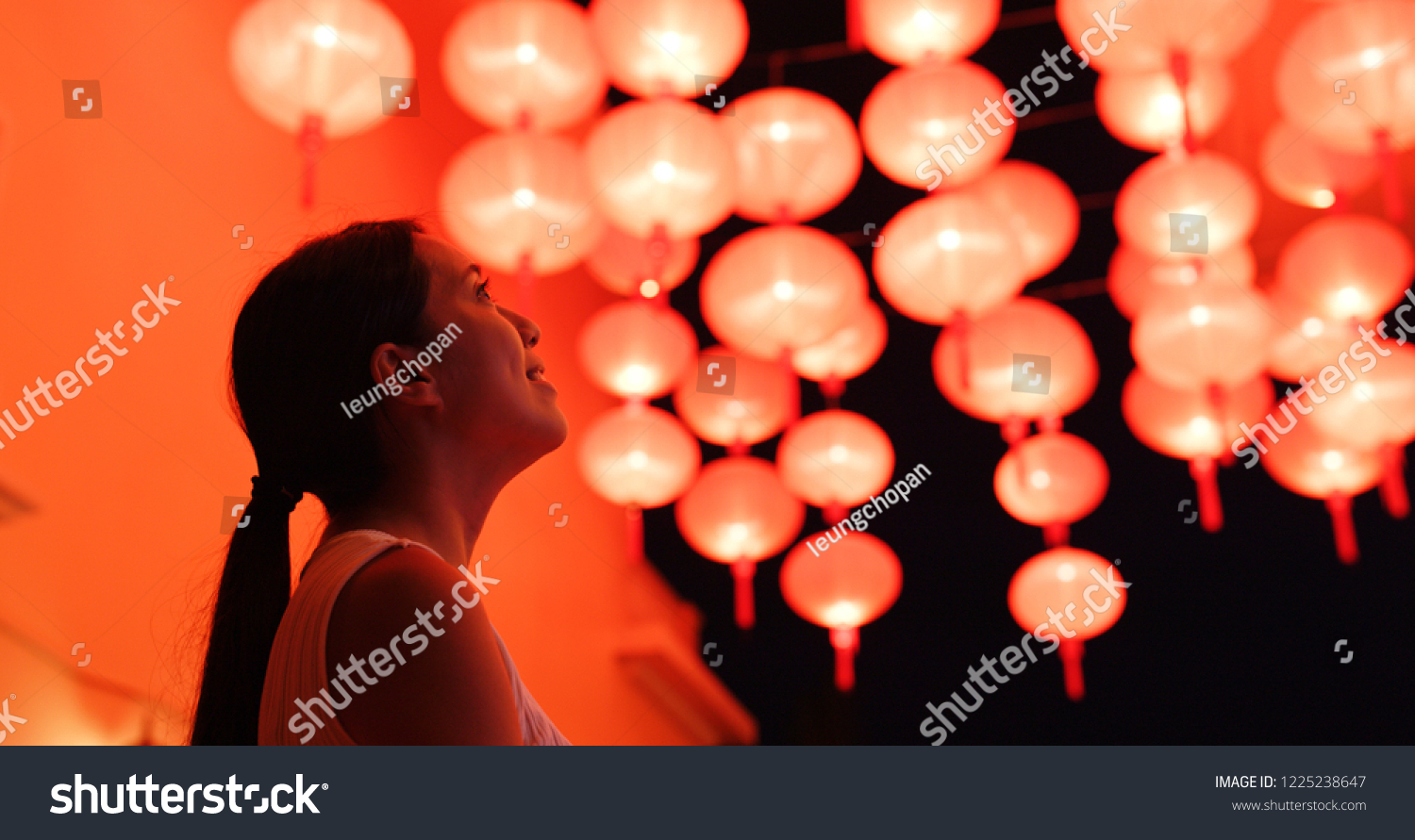 Woman look at the red lantern for Chinese new year #1225238647