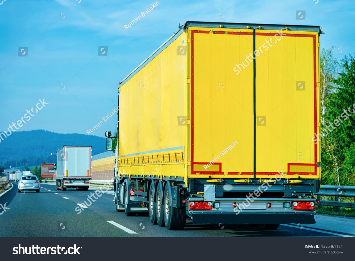 Yellow Truck on the alphalt road of Poland. Lorry transport delivering some freight cargo. #1225461181