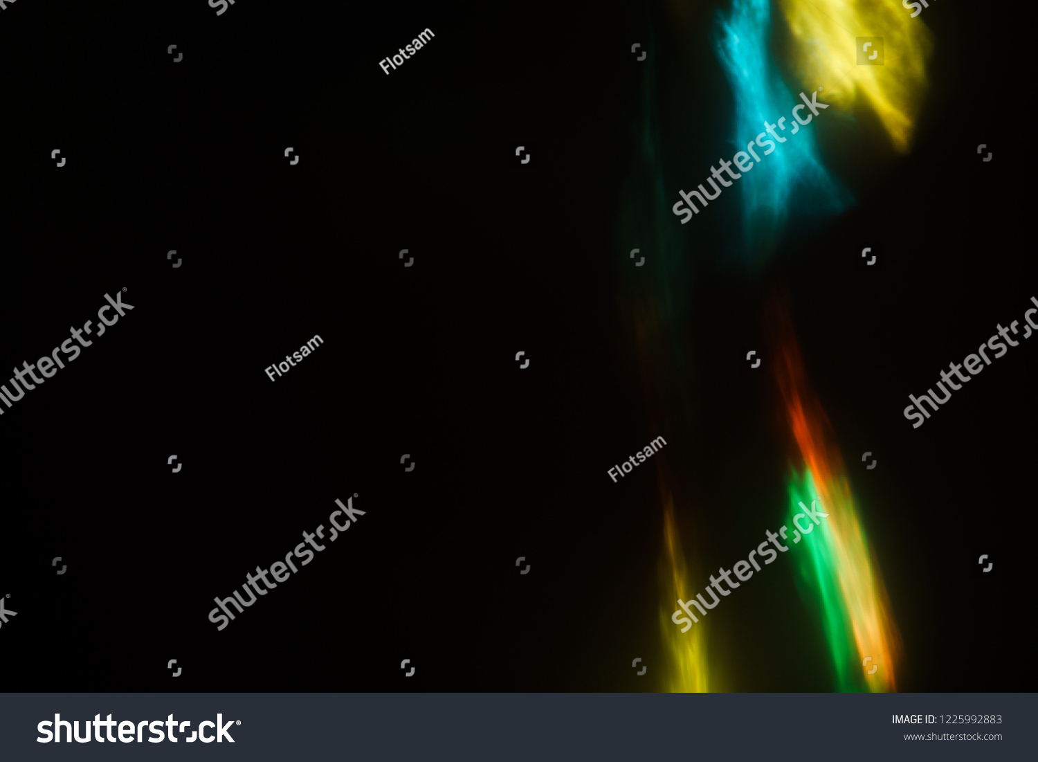 blurred defocused color light flashes and rays. lens flare effect. creative abstract background. festive disco nightlife atmosphere #1225992883