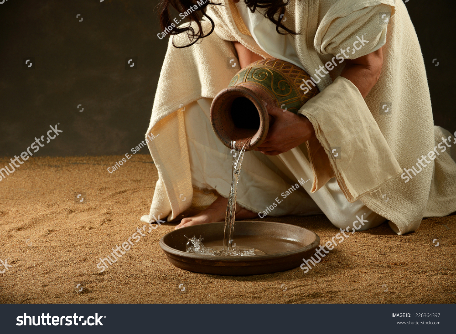 Jesus pouring water from a jar before washing - Royalty Free Stock ...