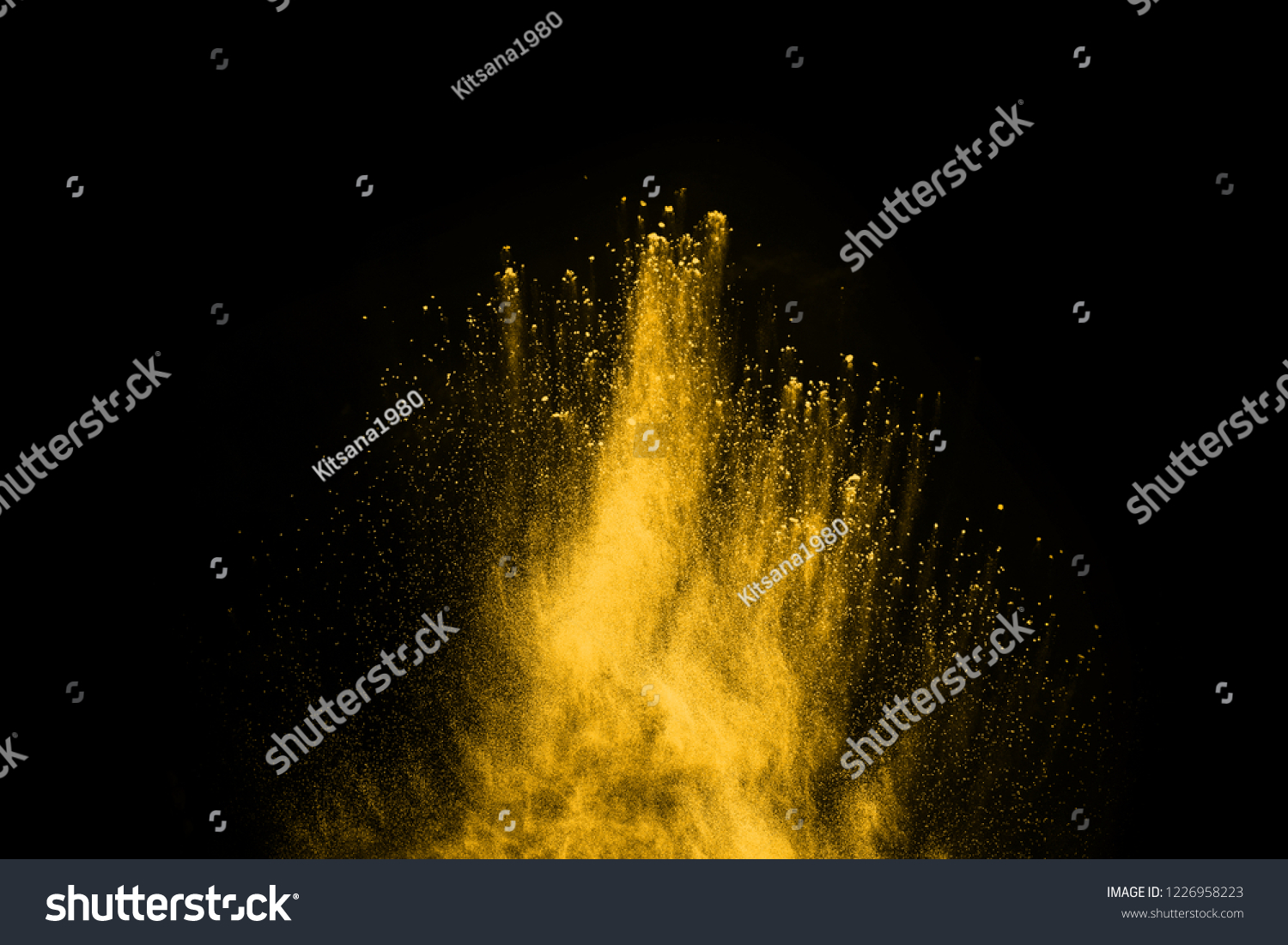 Freeze motion of yellow dust explosion isolated on black background #1226958223