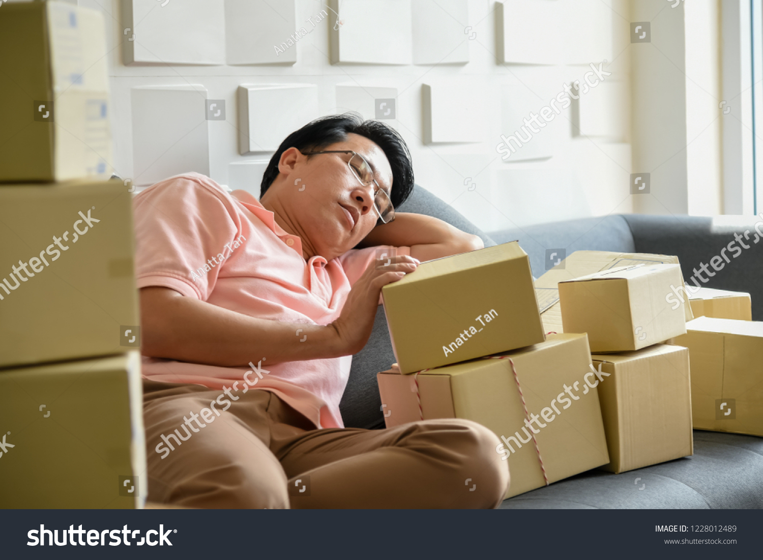 Asian men are falling asleep Because to tired of handling the order-based goods from online customers, which there are many, to SME concept. #1228012489