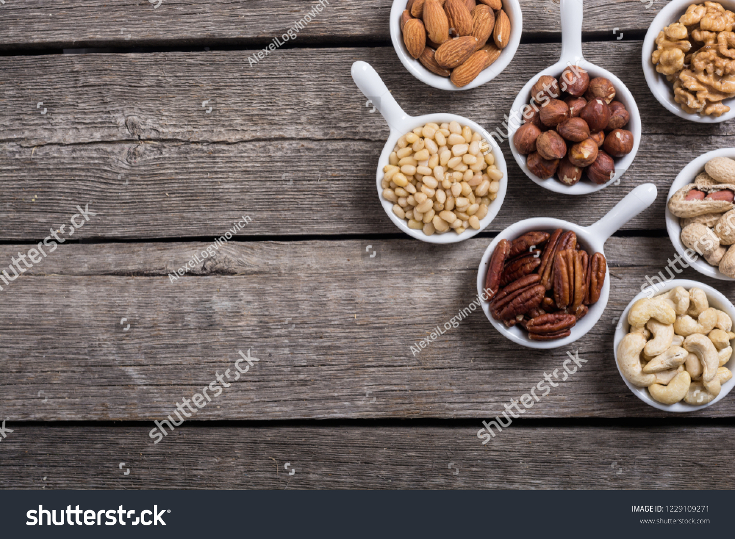 Mix of nuts : Pistachios, almonds , walnuts , pine nut , hazelnuts and cashew . Snack in bowl backgrond #1229109271