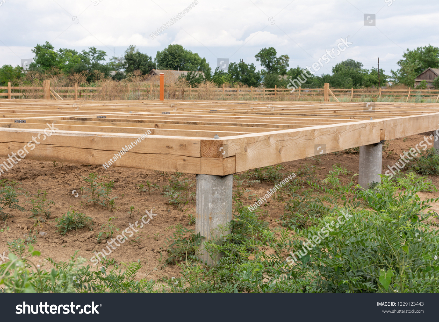 On pile foundations support the floor of a frame house #1229123443