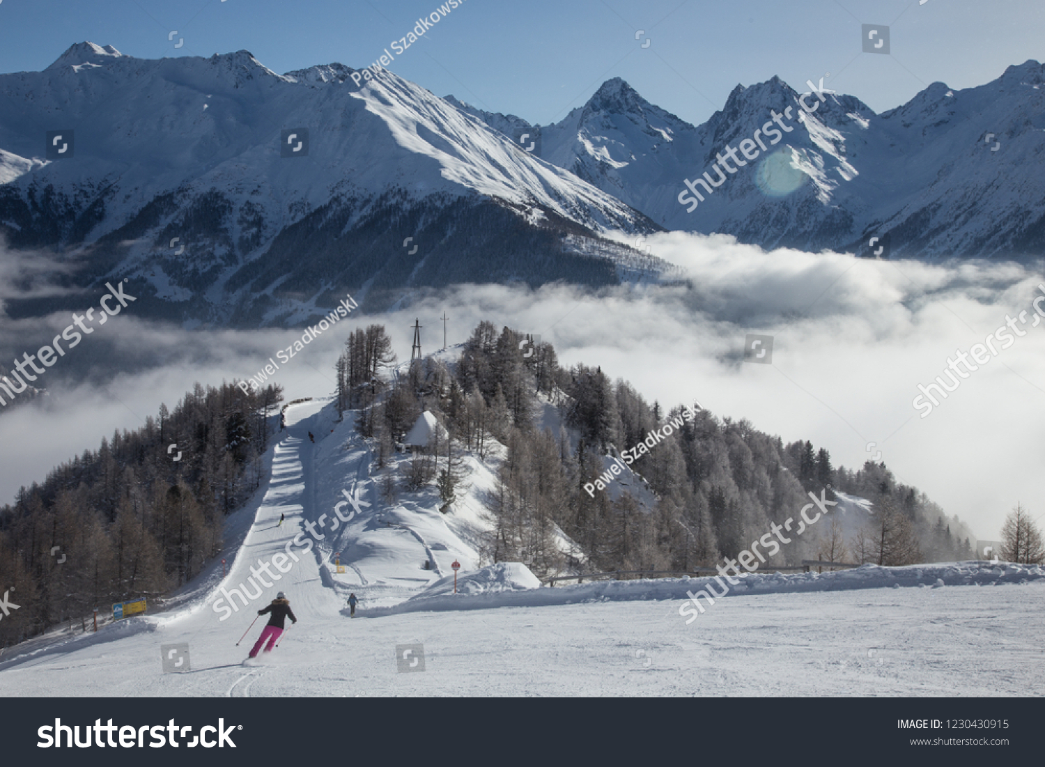 Matrei in Osttirol, Grossglockner Resort, Austria. Snowy ski slope. Skiers on the slope. Mountains in the background. #1230430915