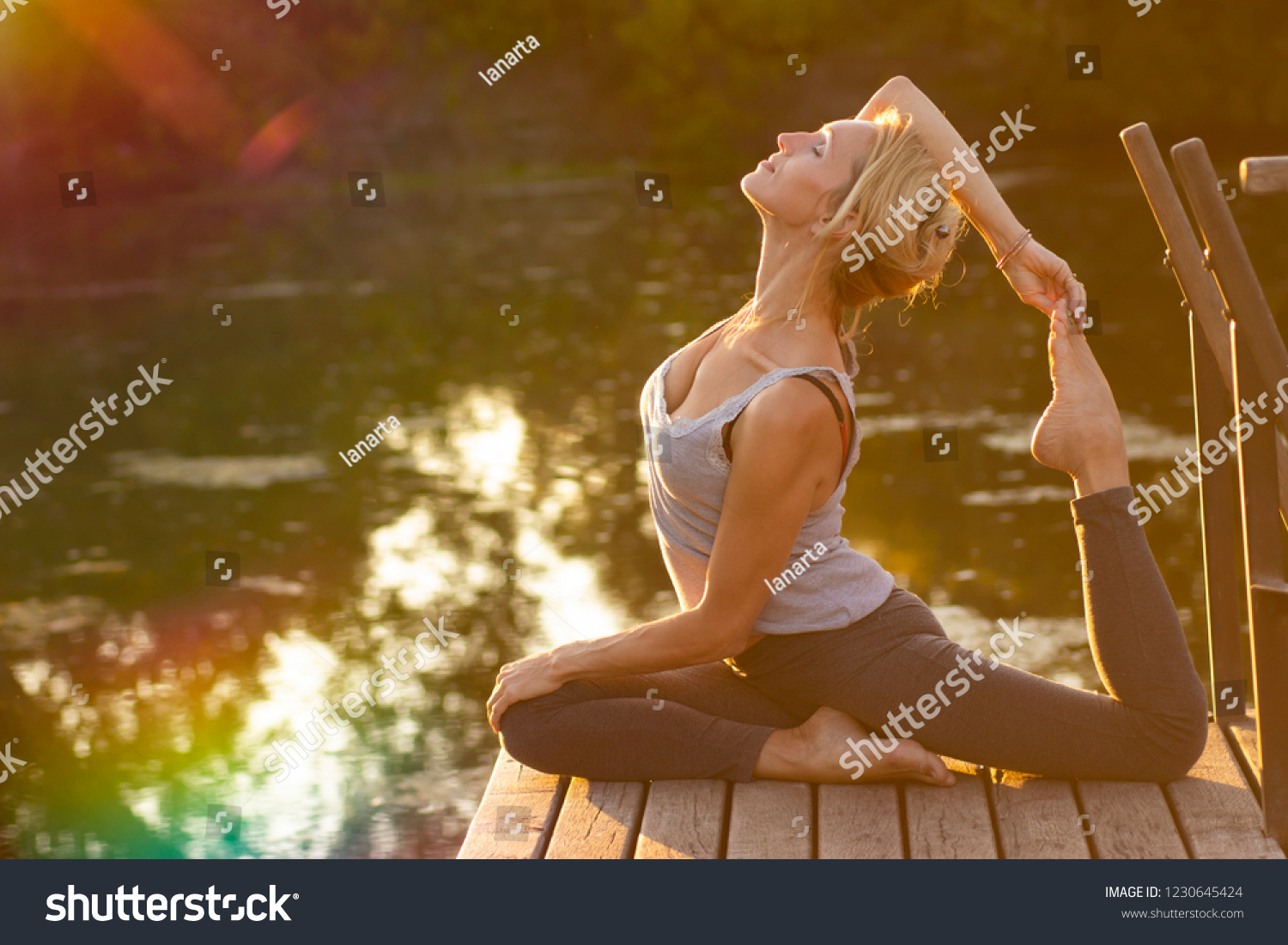 Young happy  woman  practicing yoga in nature #1230645424