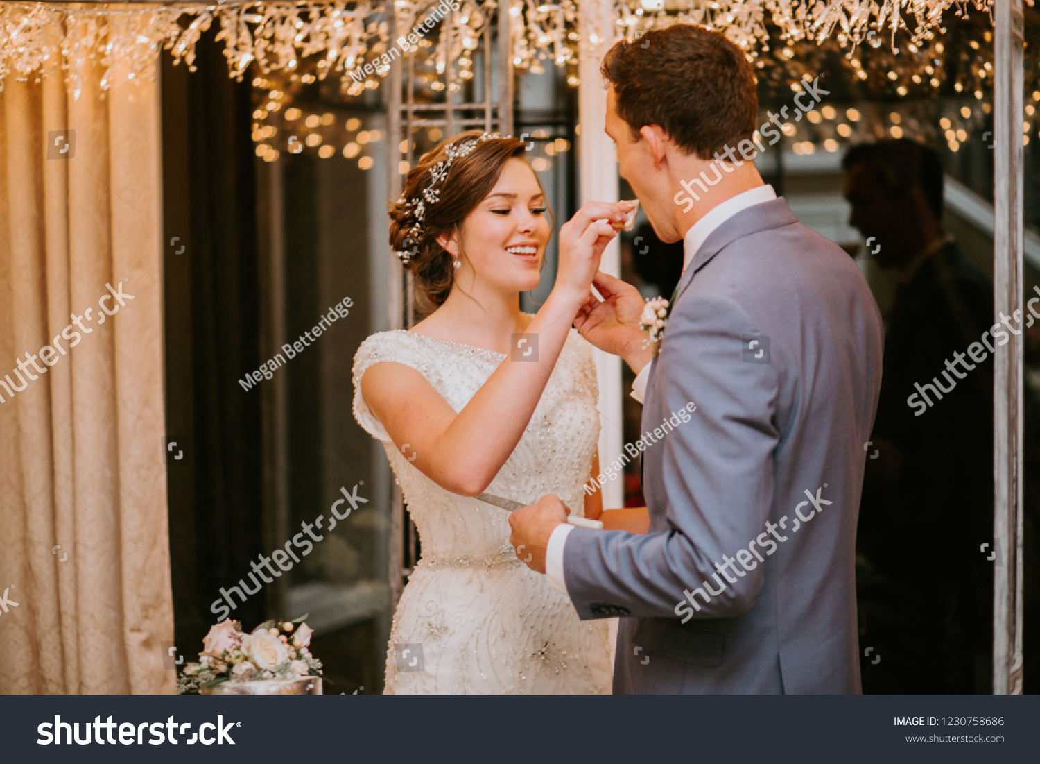 Happy couple Cutting the Wedding Cake on Wedding Day #1230758686