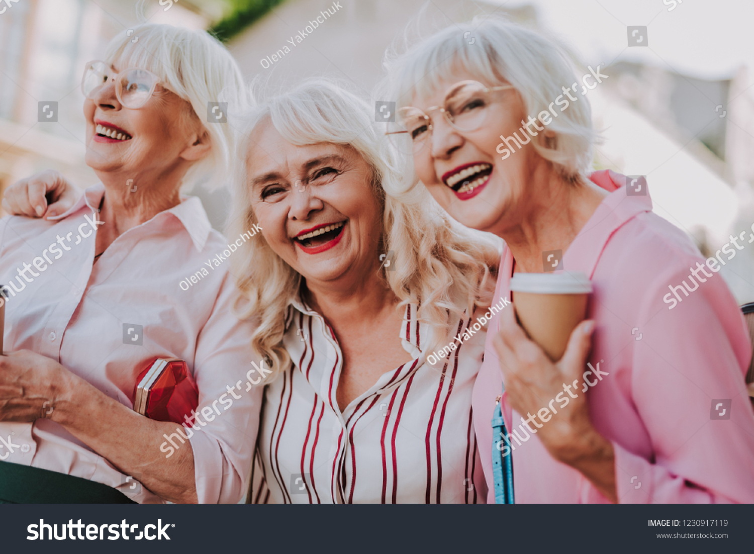 Waist up portrait of three positive older women joking and having fun together #1230917119