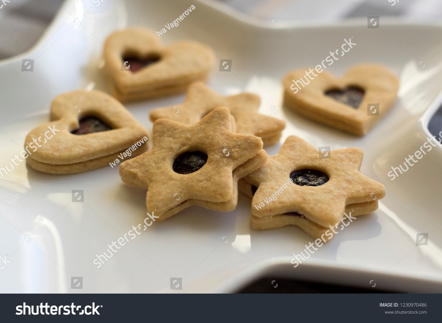 Christmas sweets and cookies made from shortcrust pastry, various shapes filled with marmalade and decorated with chocolate, star shaped plate #1230970486