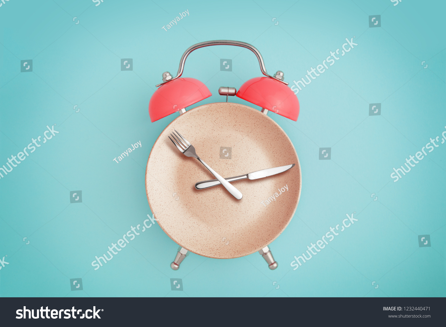 Alarm clock and plate with cutlery . Concept of intermittent fasting, lunchtime, diet and weight loss #1232440471
