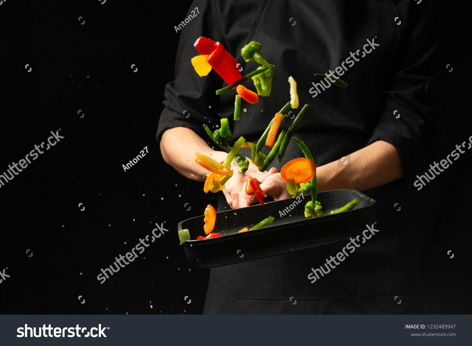Professional cook. He prepares a dish with vegetables in a saucepan. on black background, menu, recipe book, healthy food #1232489947