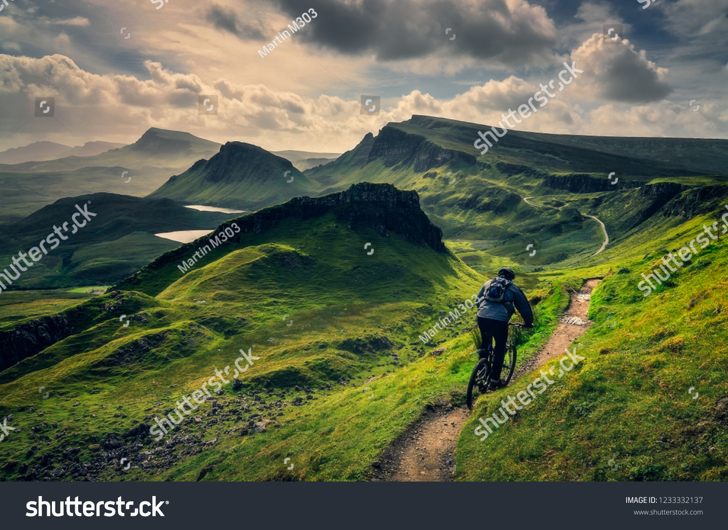 Mountain biker riding through rough mountain landscape of Quiraing, Isle of Skye, Scotland, UK #1233332137