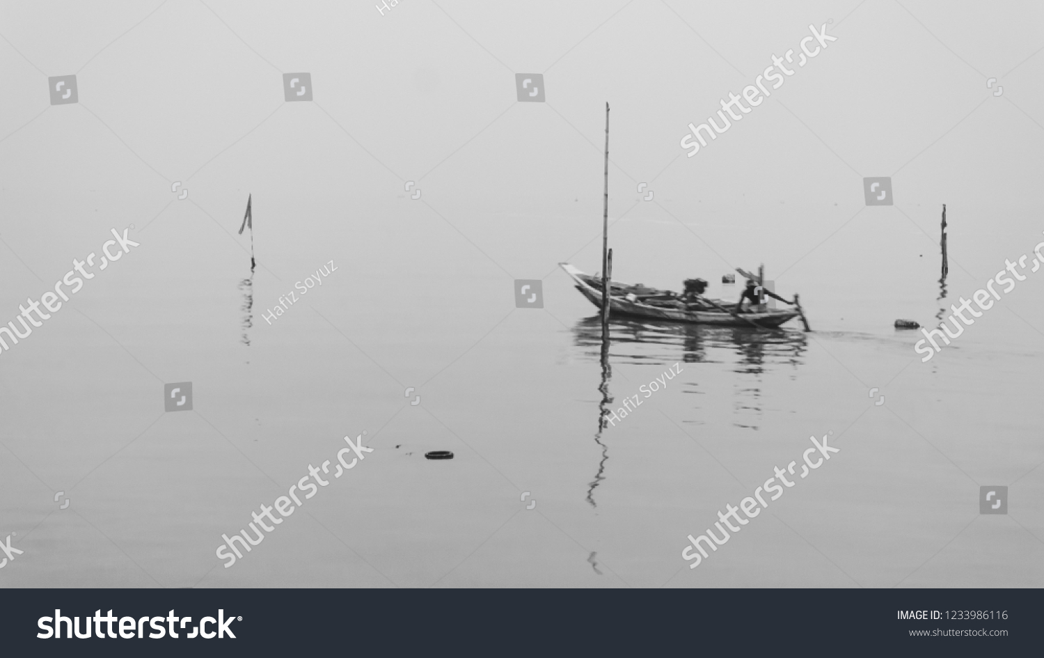 Amazing fine art black & white landscapes photograph of a fisherman boat on the beach at Pantai Kenjeran, Surabaya. (noise grain soft focus motion blurry due to long exposure) Nature composition #1233986116