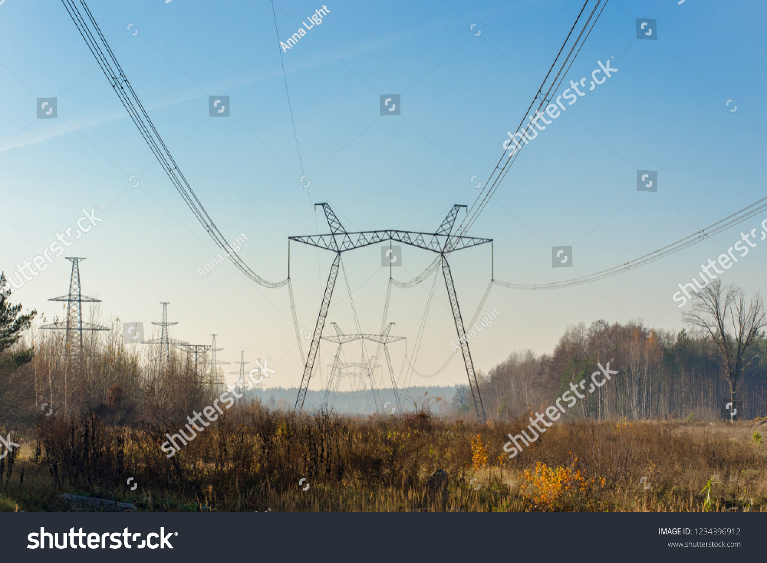 High voltage powerline against the forest. #1234396912