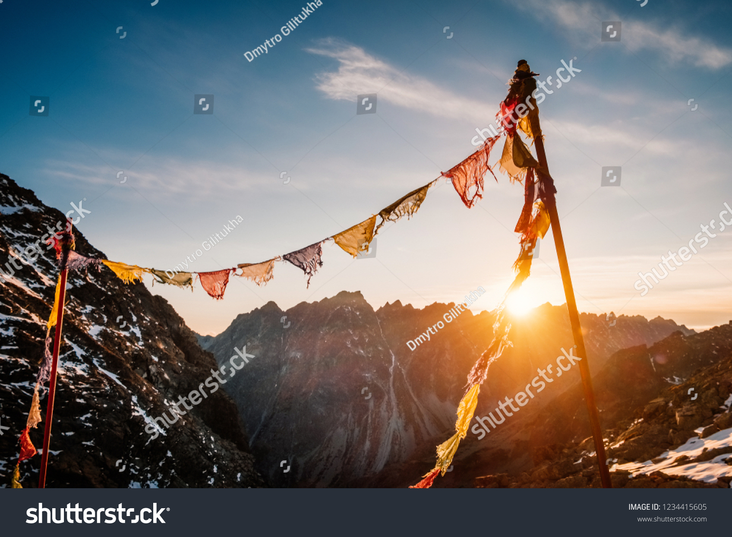 Peaceful praying flags fluttering on the wind in Rysy winter mountain at sunset in Slovakia #1234415605