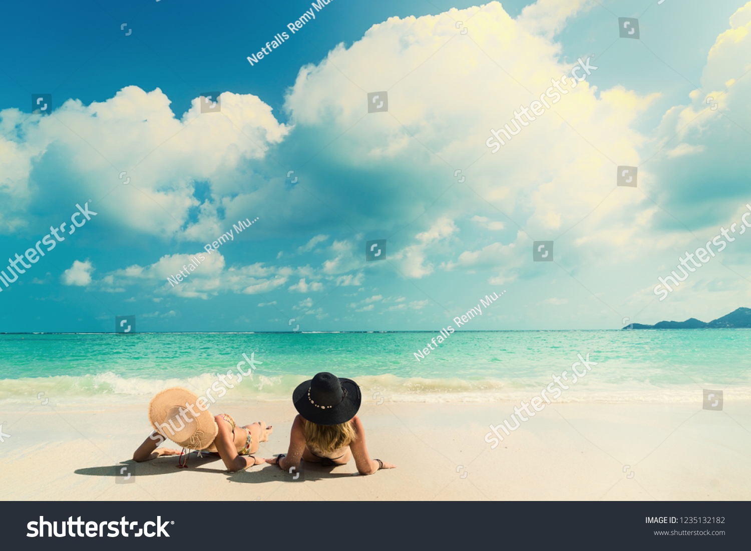 Woman suntanning - Winter holidays at the tropical beach #1235132182