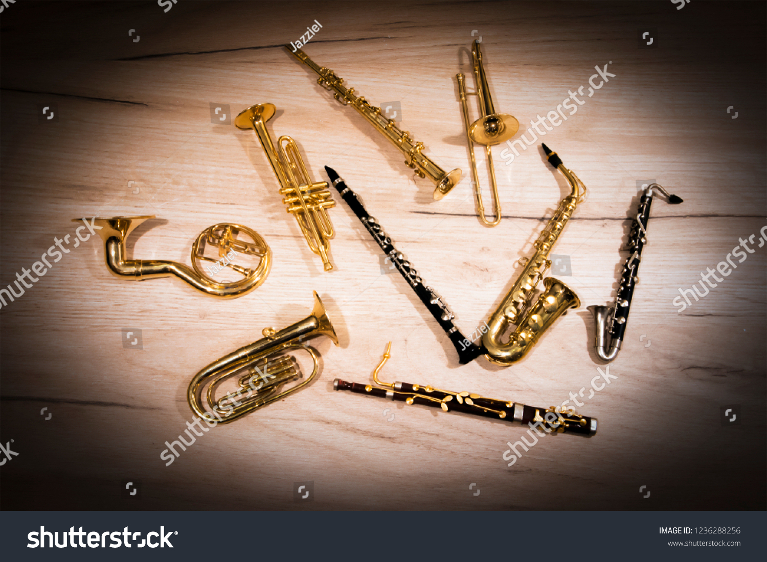 A number of toy wind instruments  lying on a wooden board, dark vignette #1236288256