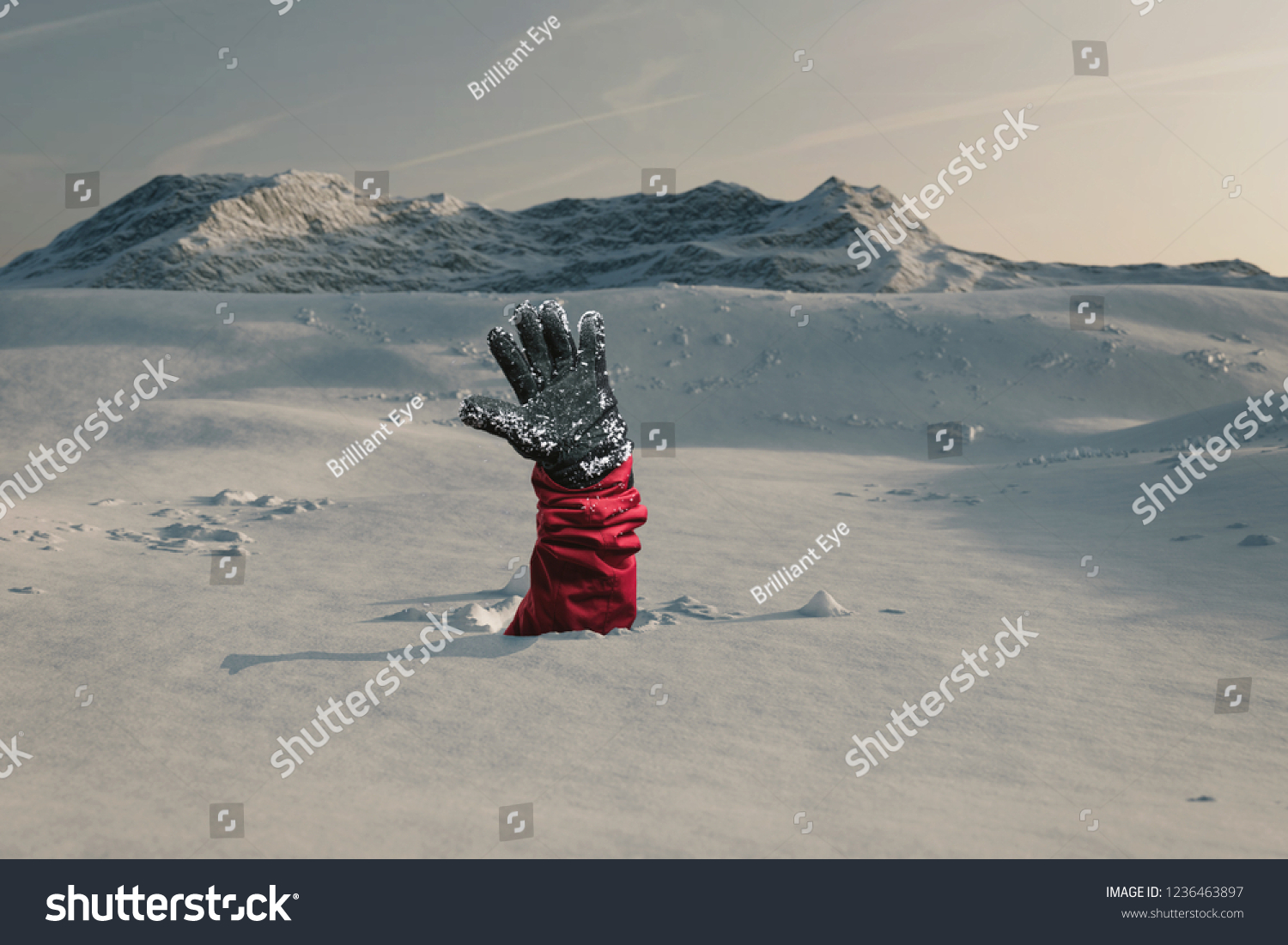 Hiker stretching out his snow covered hand to signal help because of snow avalanche . Danger extreme concept #1236463897