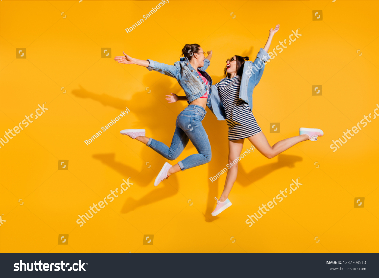Full legs body size portrait of two sweet gorgeous glad positive nice adorable good-looking lady in glasses spectacles ready hug each other jump isolated on yellow shine background raised hands up #1237708510