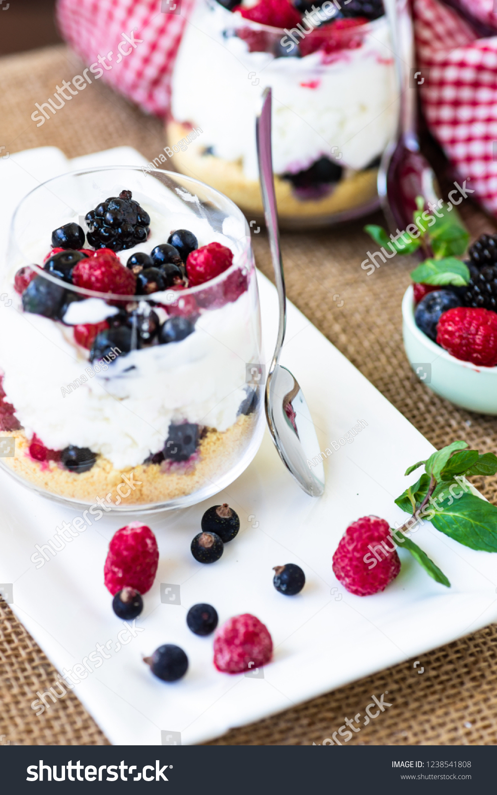 Yogurt dessert with granola and berries on rustic background #1238541808