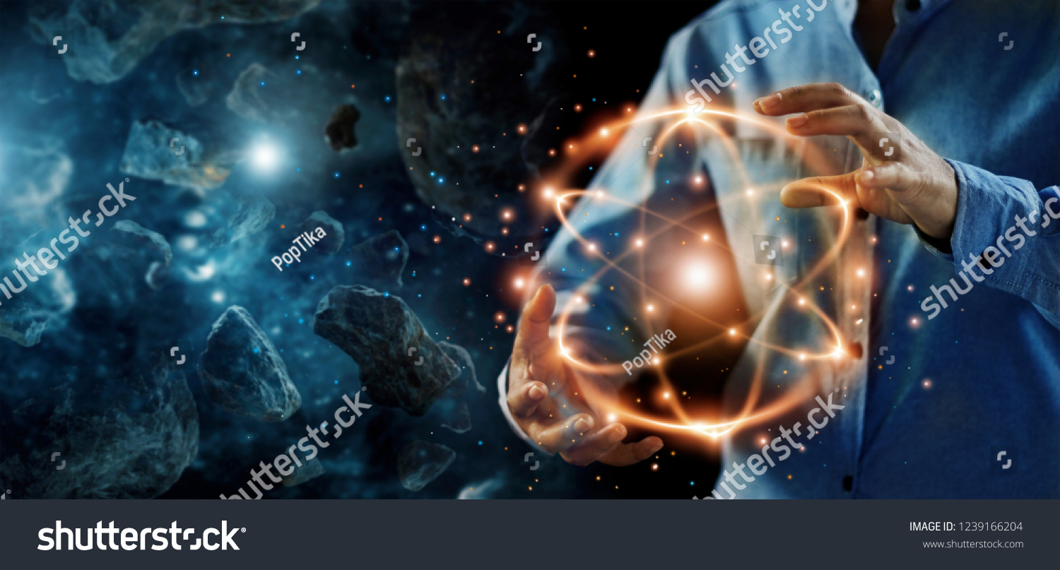 
Abstract science, hands holding atomic particle, nuclear energy imagery and network connection on meteorites space planets background. #1239166204
