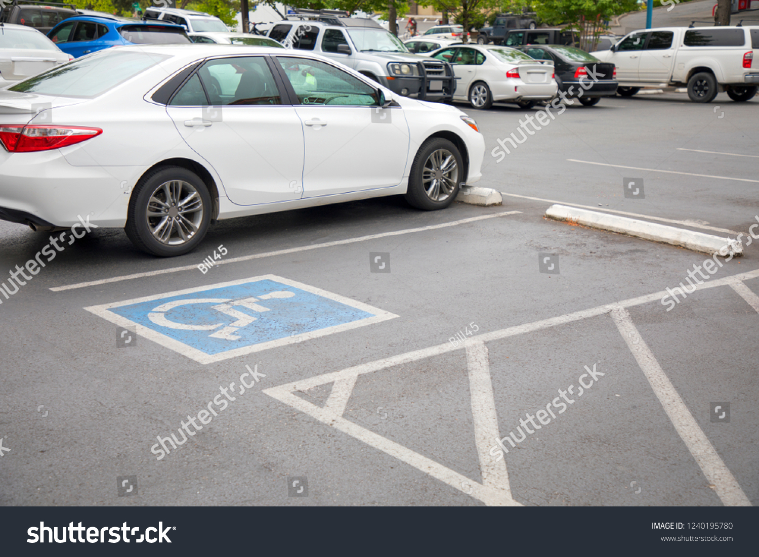 Free space Handicapped parking spot in motel or apartment, transportation infrastructure road markings. #1240195780