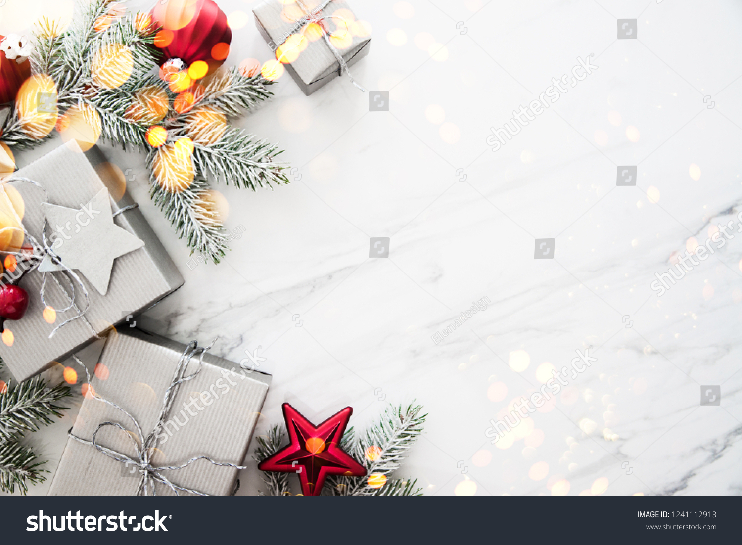 Merry Christmas and Happy Holidays greeting card, frame. New Year. Red, silver Christmas gifts, presents and ornaments on white marble background top view. Winter holiday xmas theme. Noel. Flat lay. #1241112913
