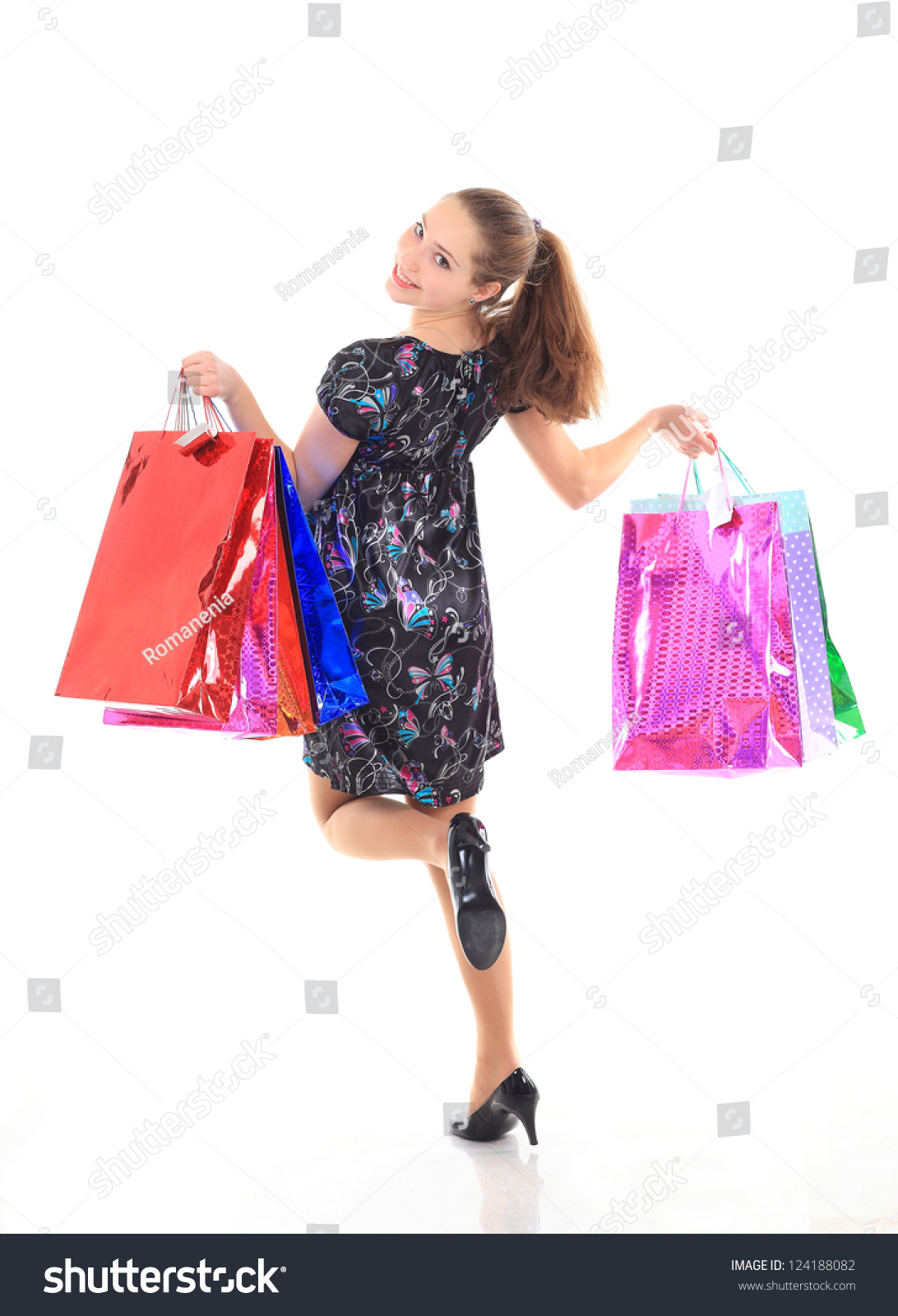 Beautiful woman with a shopping bags. Isolated on white. #124188082