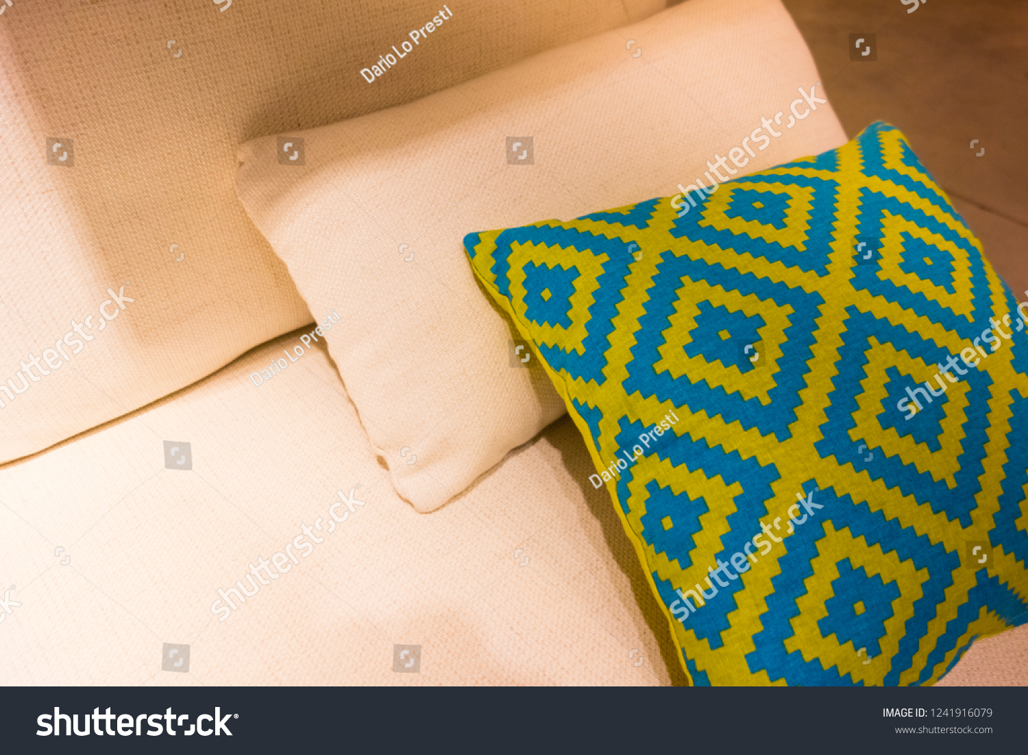 some cozy pillows on a cozy sofa in an apartment #1241916079
