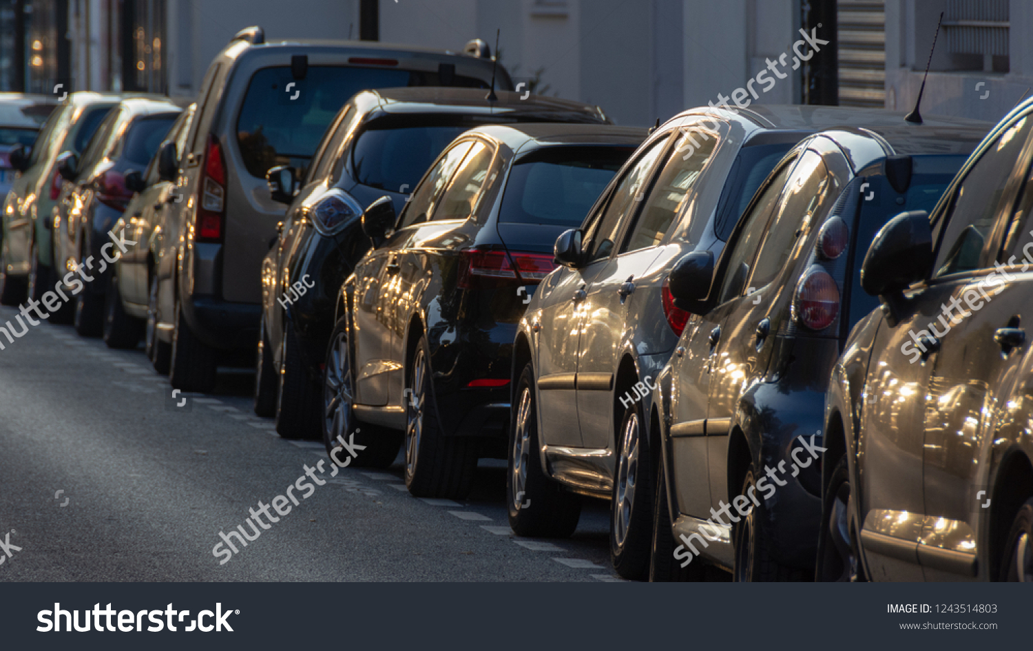 Cars parked along a street at sunset #1243514803