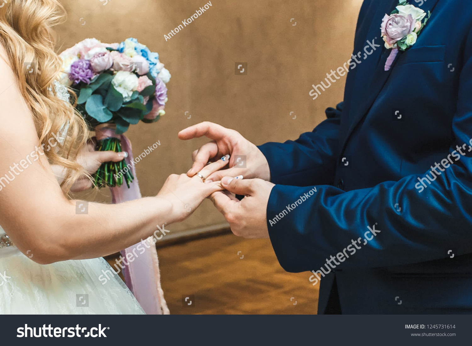 The groom wears a wedding ring to the bride. #1245731614
