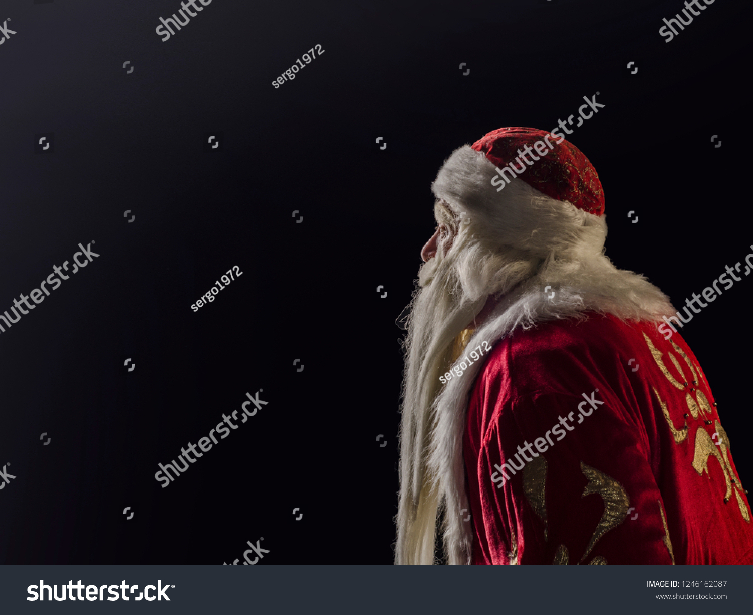 Santa Claus and Santa Claus on a black background. Santa Claus and Santa Claus majestic, looks away, in profile against a black background. #1246162087