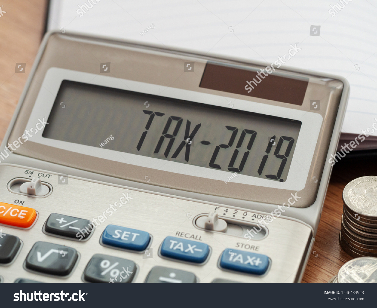 Tax word and 2019 number on calculator. Business and tax concept. Pay tax in 2019 years. #1246433923