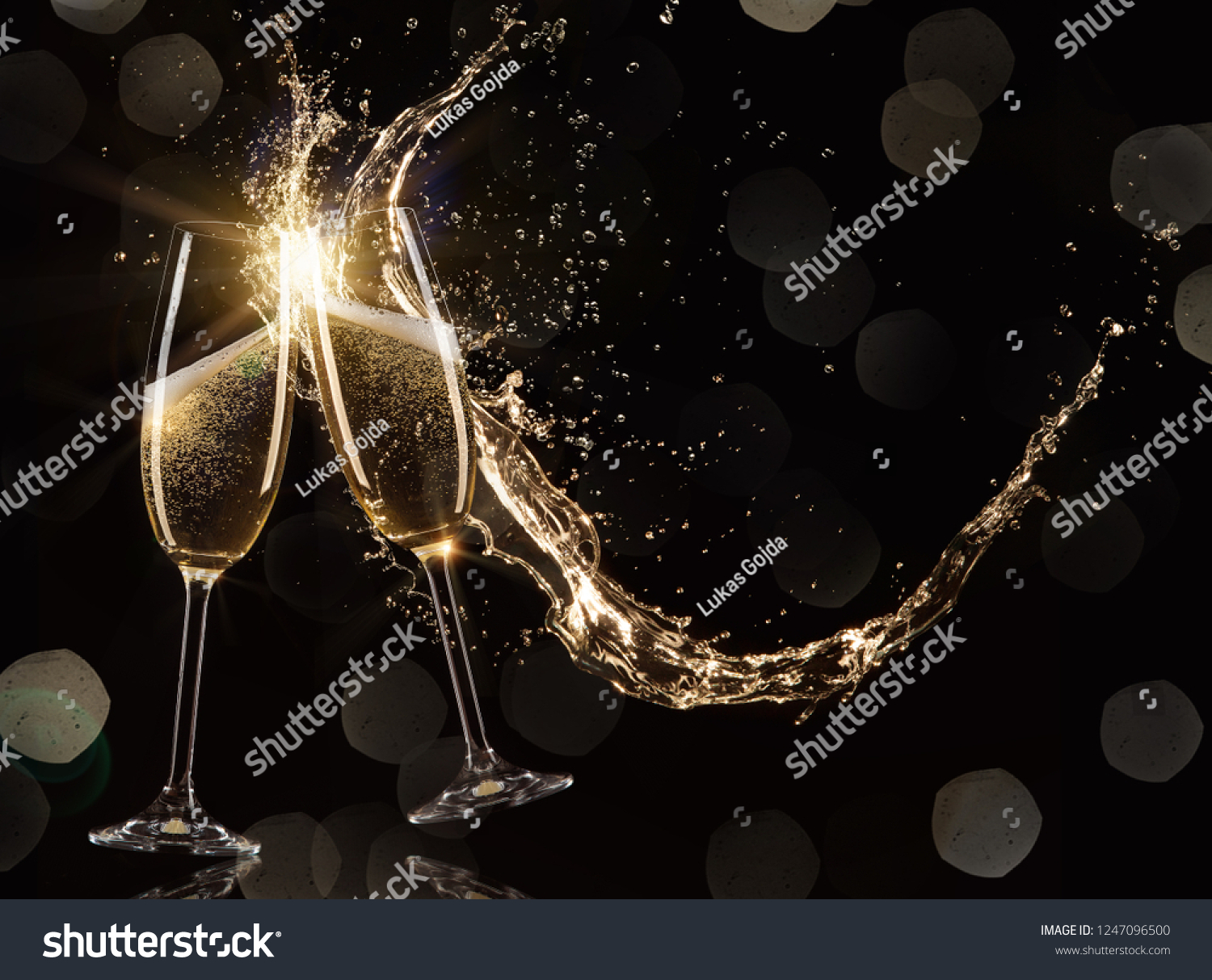 Glasses of champagne levitating in the air, celebration theme. #1247096500