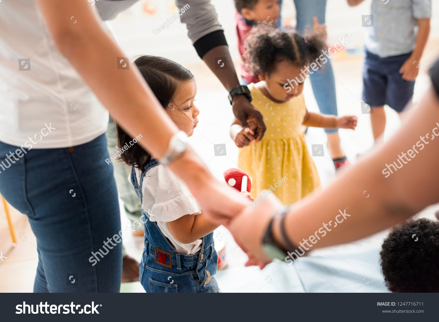 Young diverse kids standing with their parents #1247716711