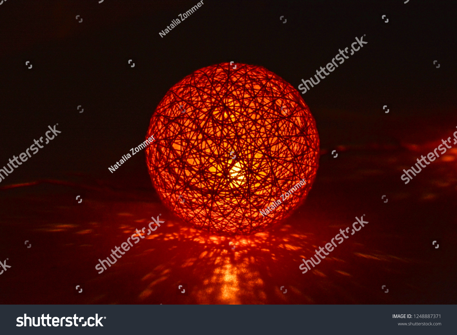 A bright glowing ball from Christmas garland glows in the dark #1248887371
