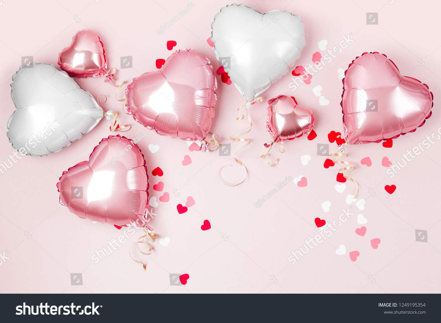 Air Balloons of heart shaped foil  on pastel pink background. Love concept. Holiday celebration. Valentine's Day or wedding/bachelorette party decoration. Metallic balloon #1249195354